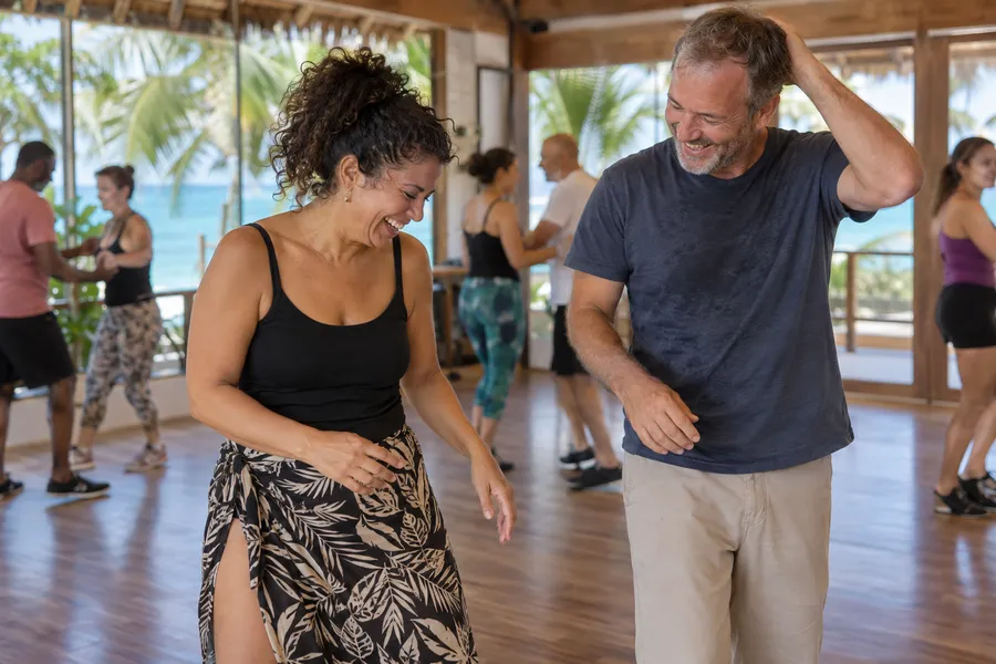 Bachata learners laughing together during a group practice