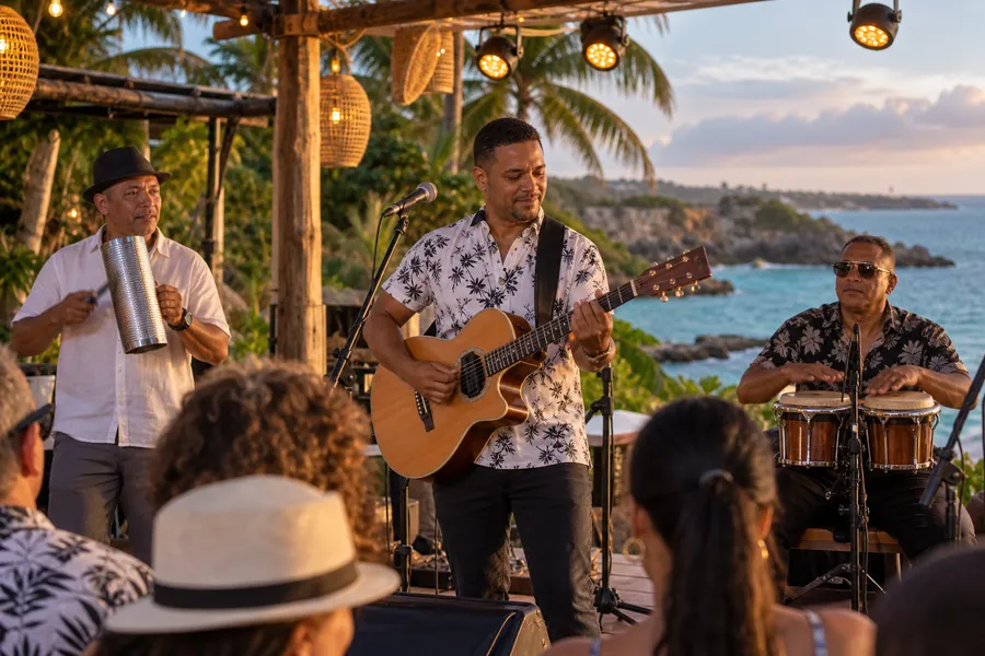 Músicos de bachata actuando en un escenario al aire libre al anochecer